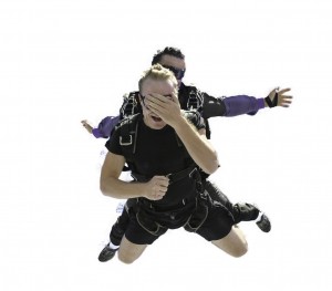 This  first time skydiver can’t bring himself to look down.  Many first timers have a complete sensory overload and can remember  nothing about the first part of the skiydive. Only after they realise that they are still alive  does the rational brain kick back in and then they open their eyes and start to enjoy the skydive. 